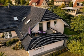 A residential building with a sloped roof, a covered patio area, and a sign indicating it is a beauty institute. - Holiday apartment with 1 bedroom (Steinbach-Hallenberg)