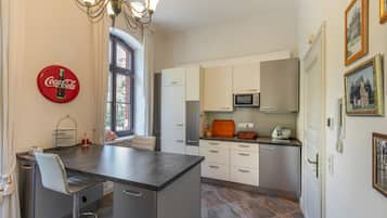 A modern kitchen with a central island, built-in appliances, and a dining area.