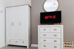 A white wardrobe with a flat-screen TV on top displaying the Netflix logo. - 4 Bed Contractor House in Sunderland, Free Parking, AH Urban Stays (Sunderland)