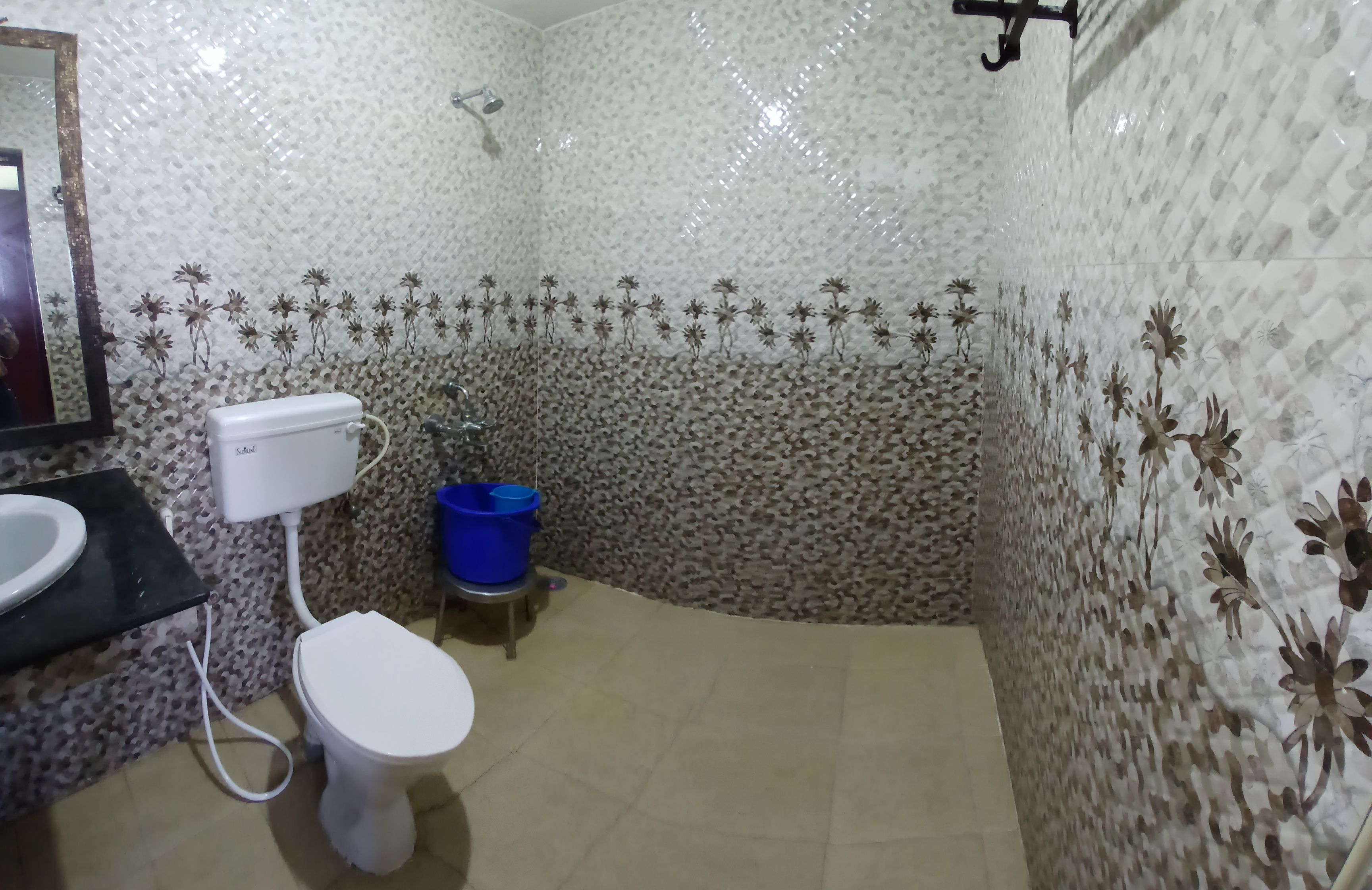 A bathroom with a toilet, sink, and shower.