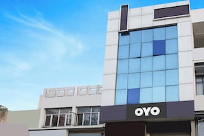 A modern building with a prominent 'OYO' sign on the facade.