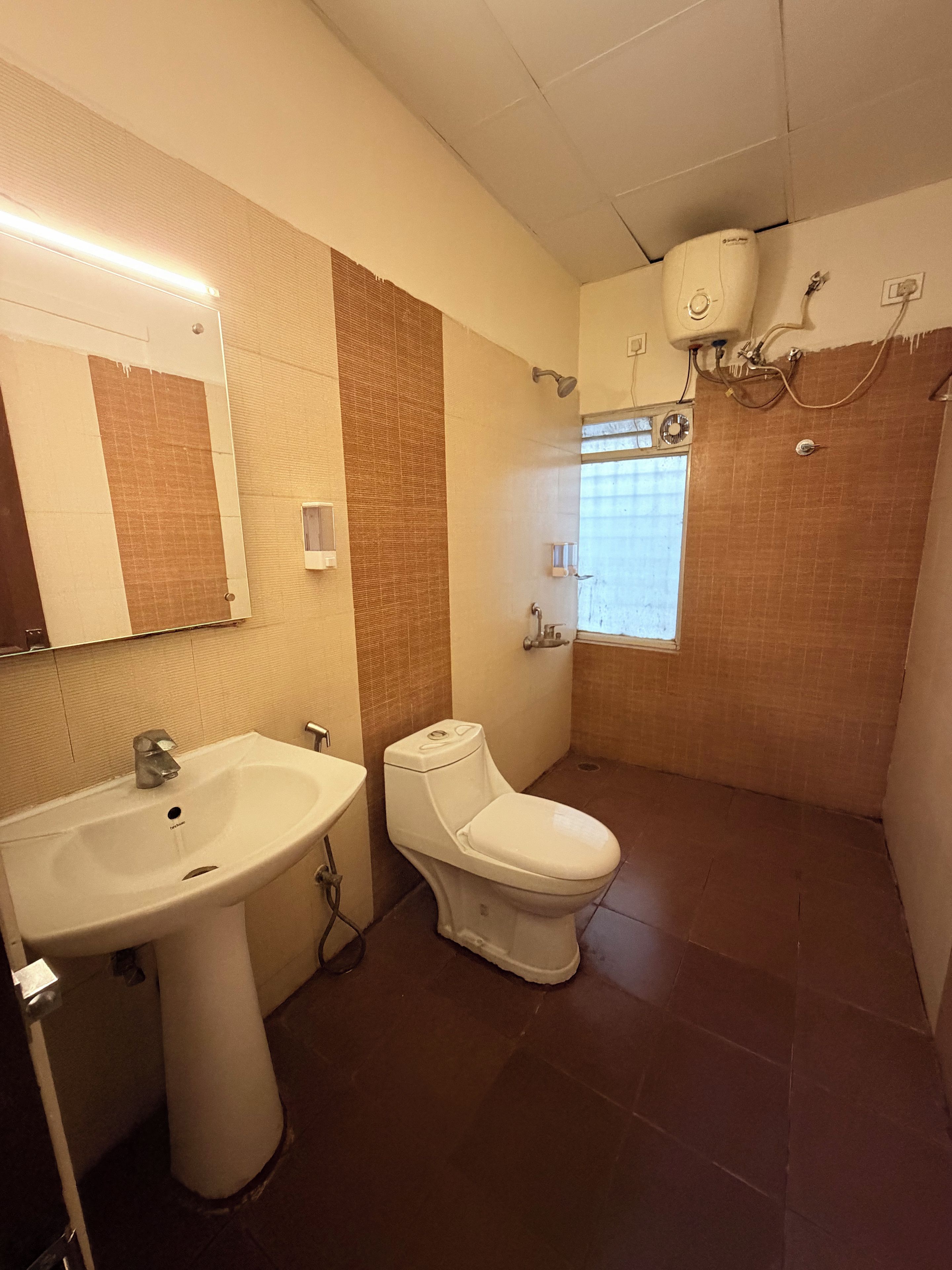 A bathroom with a sink, toilet, and shower.