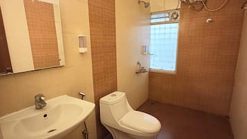 A bathroom with a sink, toilet, and shower.
