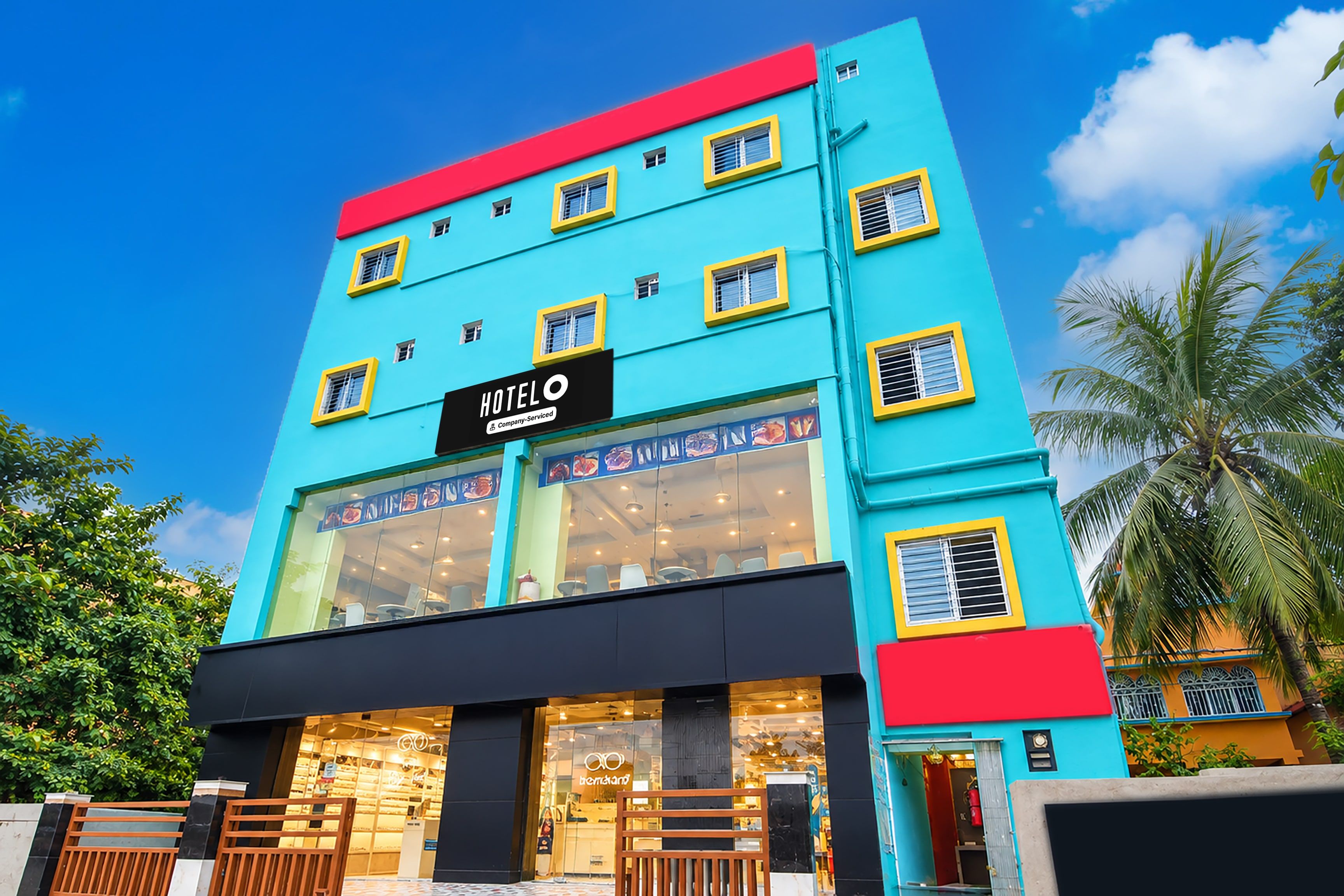 A multi-story hotel with a prominent 'HOTEL' sign, large windows, and a modern facade.