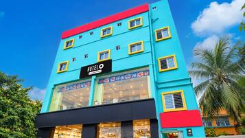 A multi-story hotel with a prominent 'HOTEL' sign, large windows, and a modern facade.
