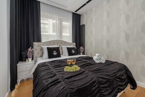 Ein Schlafzimmer mit einem Bett, einem Nachttisch, einem Fenster mit Vorhängen und einer Wand mit strukturierter Oberfläche.