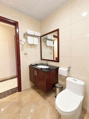 A bathroom with a toilet, sink, and mirror. - MAISON PARK (Vo Cuong)
