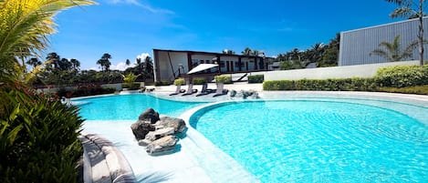 A swimming pool with a modern building in the background.