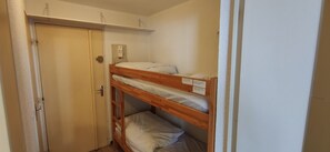 A bunk bed with a shelf above it, a door, and a wall socket. - Studio with balcony and ski slopes view (Les Deux Alpes)