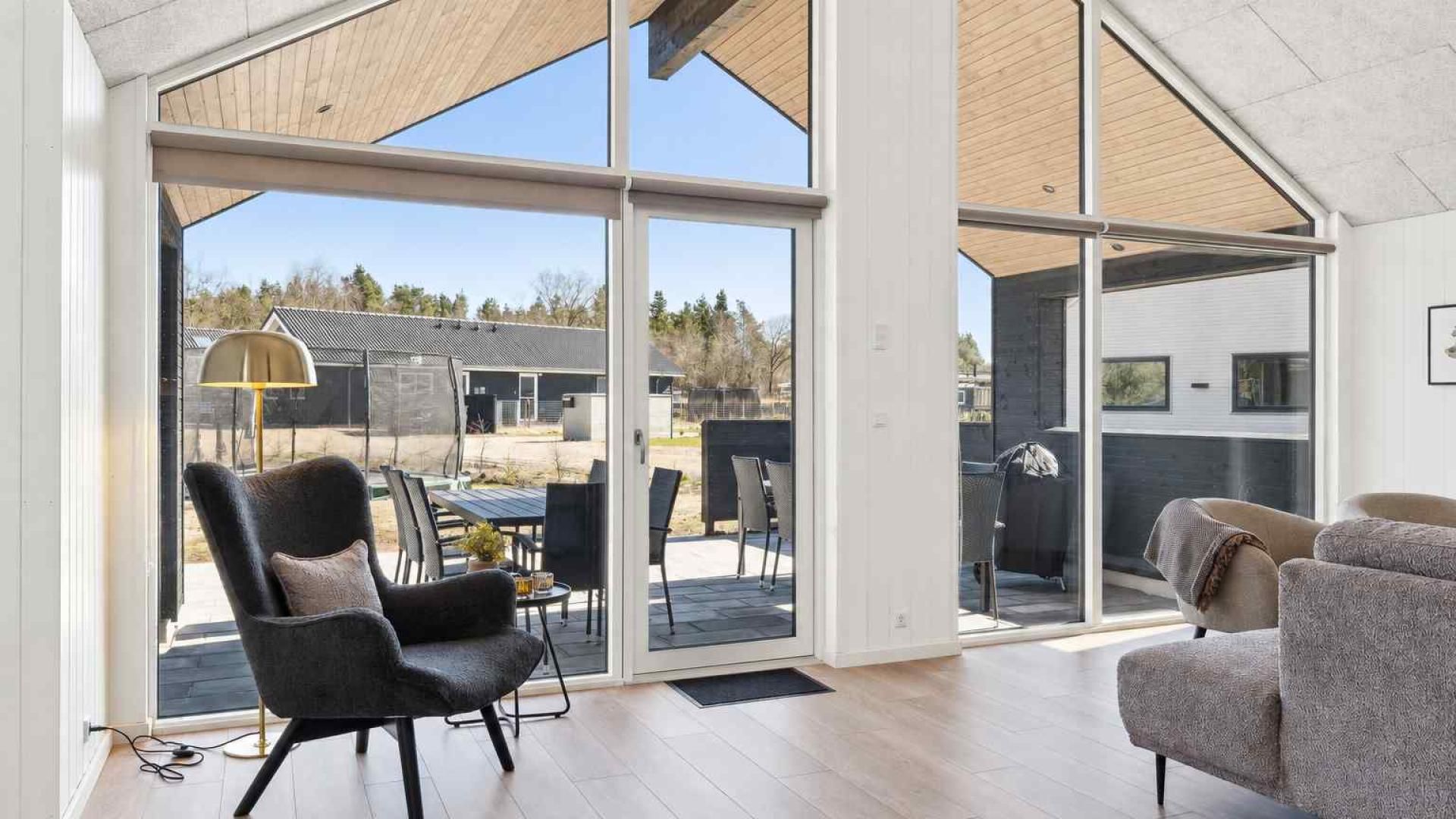 A spacious living area with a large sliding glass door leading to an outdoor patio.