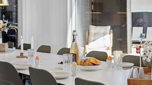 A dining table set with candles, a bottle, and plates of food. - VillaVilla 997 - Odsherred, Nordsjælland (Højby)