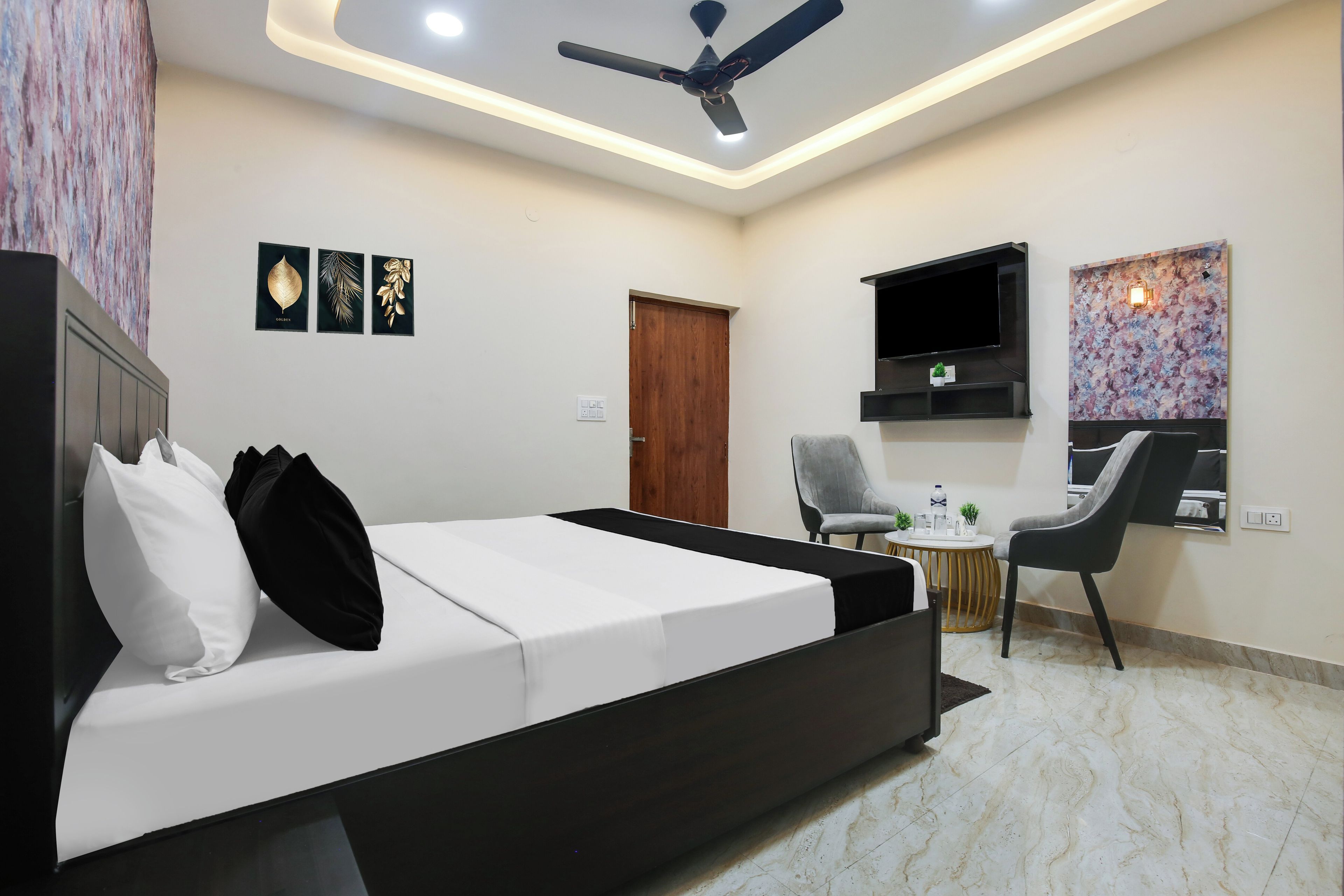 A modern bedroom with a bed, a desk, and a chair.