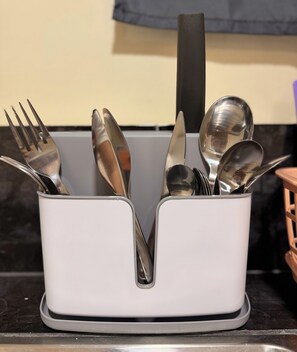 A utensil holder with forks, spoons, and a knife on a kitchen counter. - INARI SORA Soothing Studio Newly Built Guesthouse in LU (San Juan)