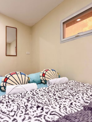 A bedroom with a bed, pillows, a window, and a mirror. - INARI SORA Soothing Studio Newly Built Guesthouse in LU (San Juan)