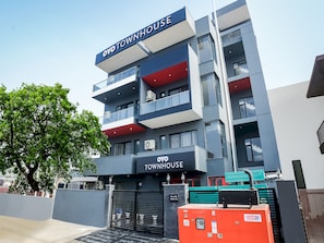 A multi-story building with a sign reading 'OYO TOWNHOUSE.' - Townhouse Artemis Hospital  (Gurugram)