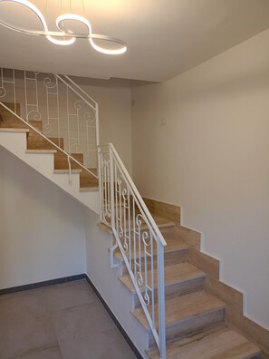 A staircase with white railings and wooden steps.