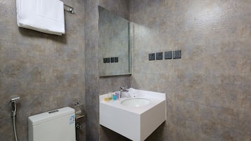 A bathroom with a white sink, mirror, and towel rack.