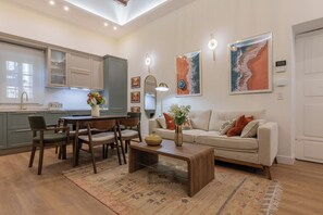 A modern living room with a sofa, coffee table, and dining area. - San Francesco Boutique House by Wonderful Italy. (Torino)