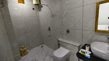 Un baño con inodoro, lavabo y ducha.
