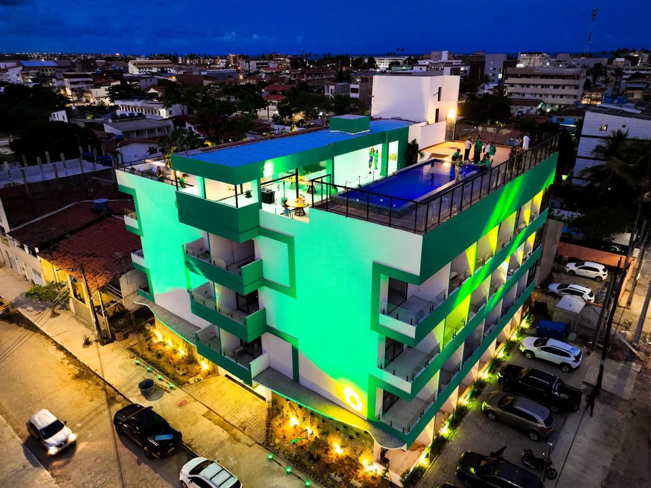 A multi-story building with balconies and a rooftop pool.