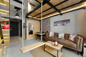 A modern living room with a brown leather sofa, a wooden coffee table, and a swing chair. - New York industrial style JVC (Dubai)