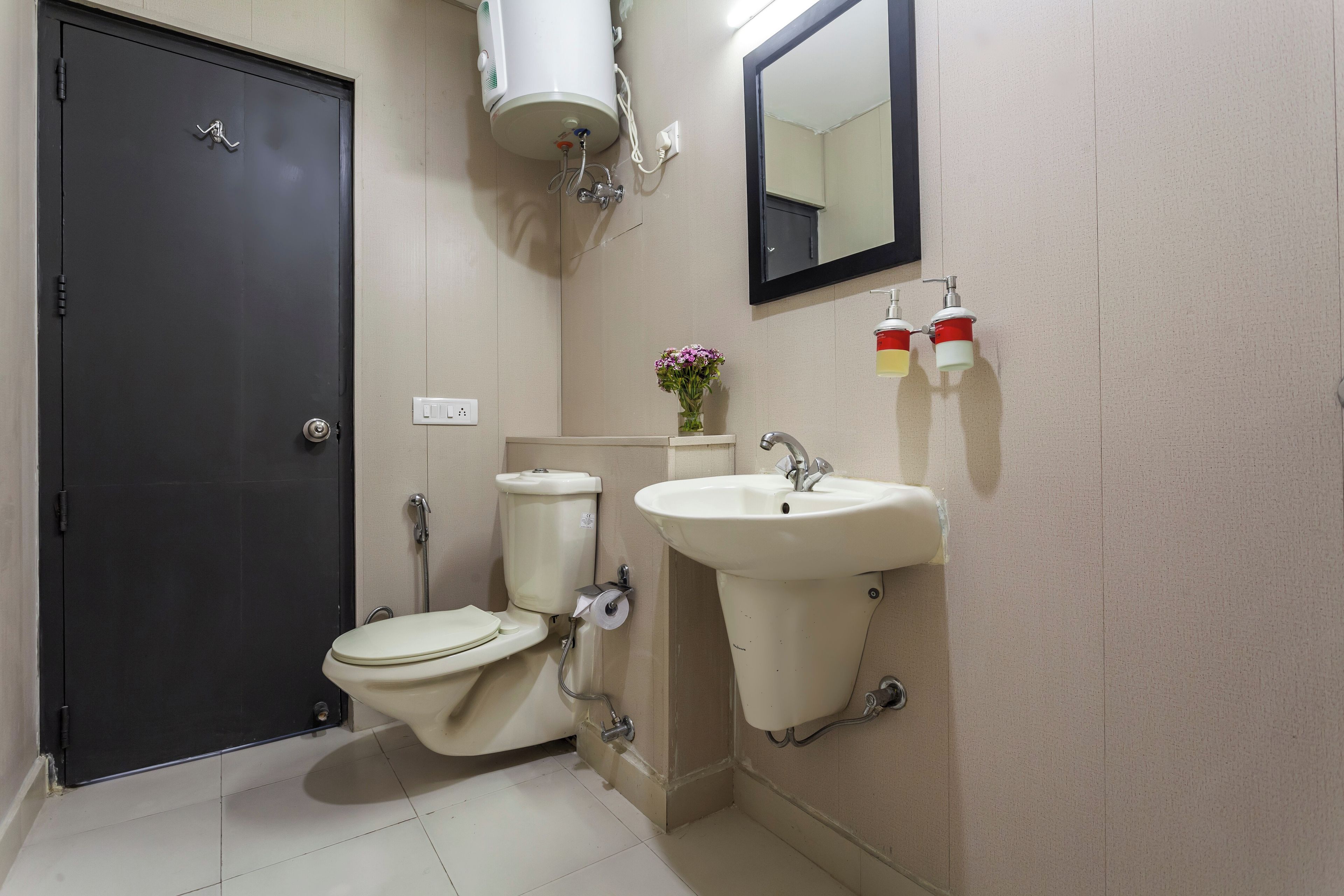 A bathroom with a toilet, sink, and a shower.