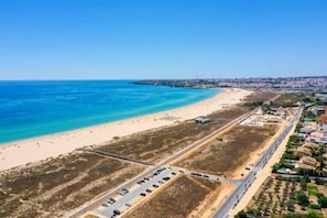 A coastal road with a beach and residential area. - Stunning Old Town apartment with large terrace. (Lagos)