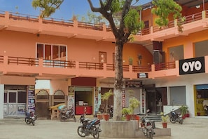 A multi-story building with a sign for 'OYO' hotel entry.