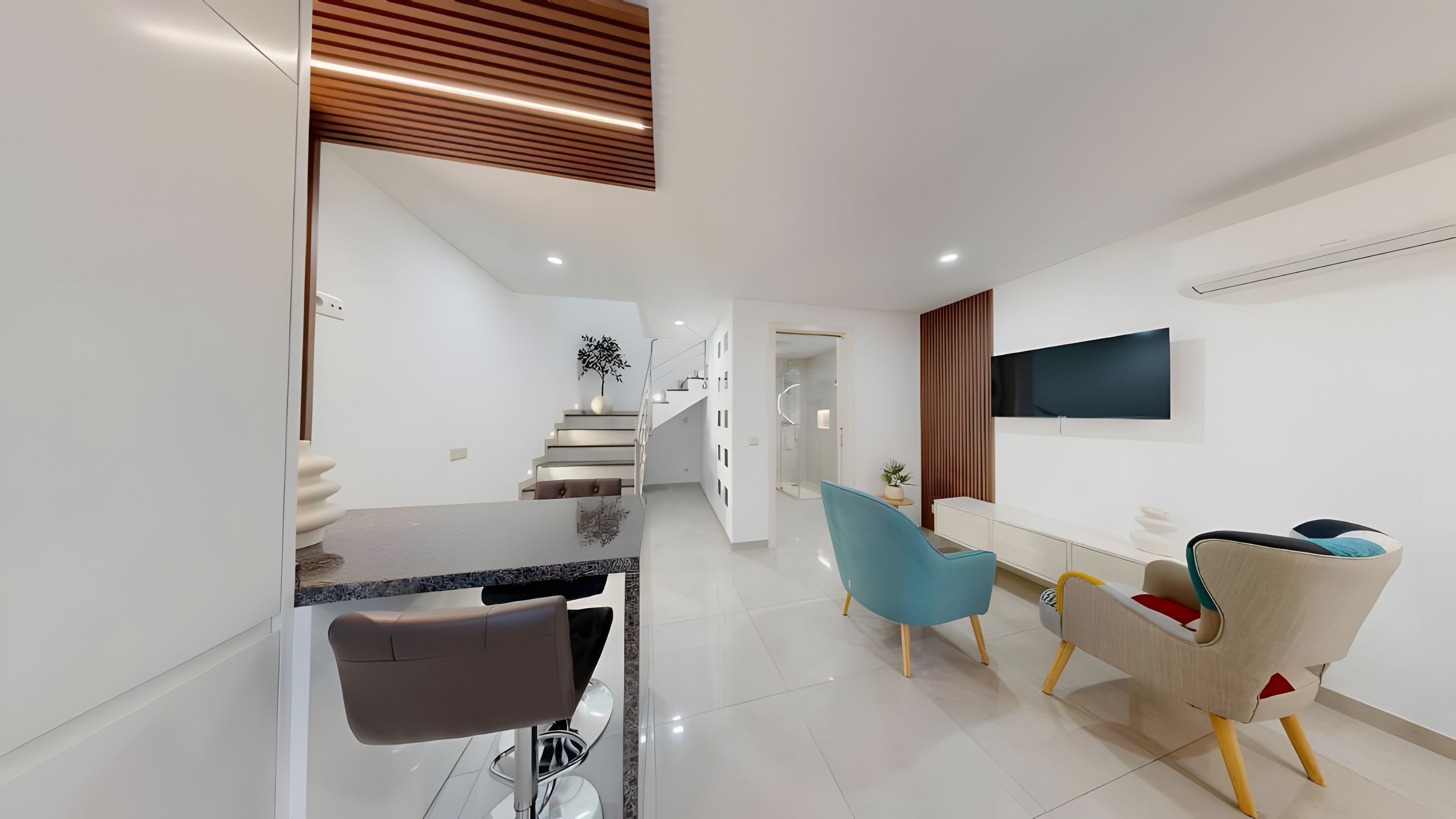 Un intérieur moderne comprenant un coin repas, une cuisine et un espace de vie.