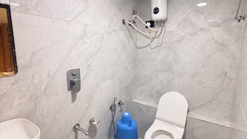 Un baño con inodoro, bidé y lavamanos.