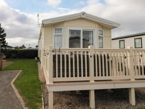 A single-story mobile home with a fenced deck and a large window. - Brookwood Willerby, 36 Bay View (Filey)