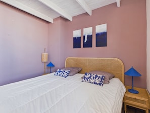 A bedroom with a bed, two wall-mounted lamps, and three paintings. - House for 6, pool & garden, walk everywhere (Noirmoutier-en-l´Ile)