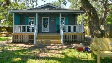 A single-story house with a porch, a front door, and a small front yard.