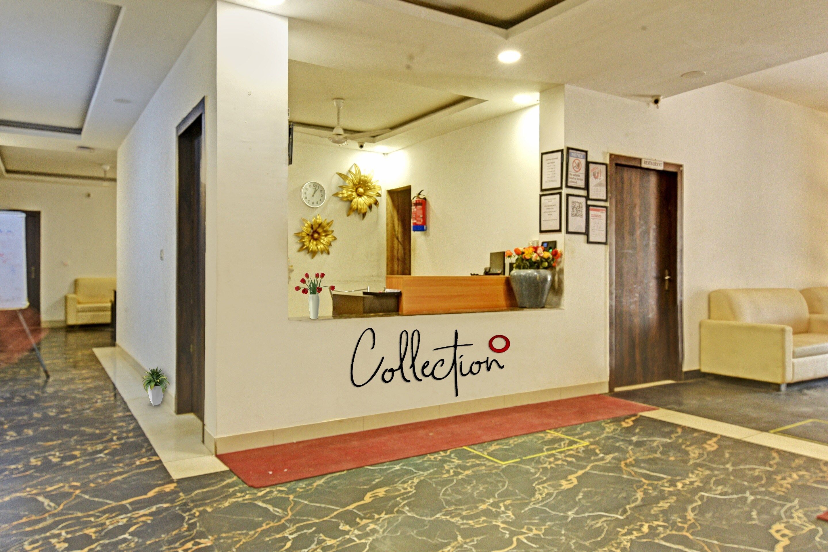 A reception area with a desk, a clock, and a sign that reads 'Collection'.