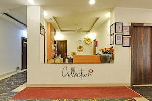 A reception area with a 'Collection' sign, a clock, and a fire extinguisher on the wall.