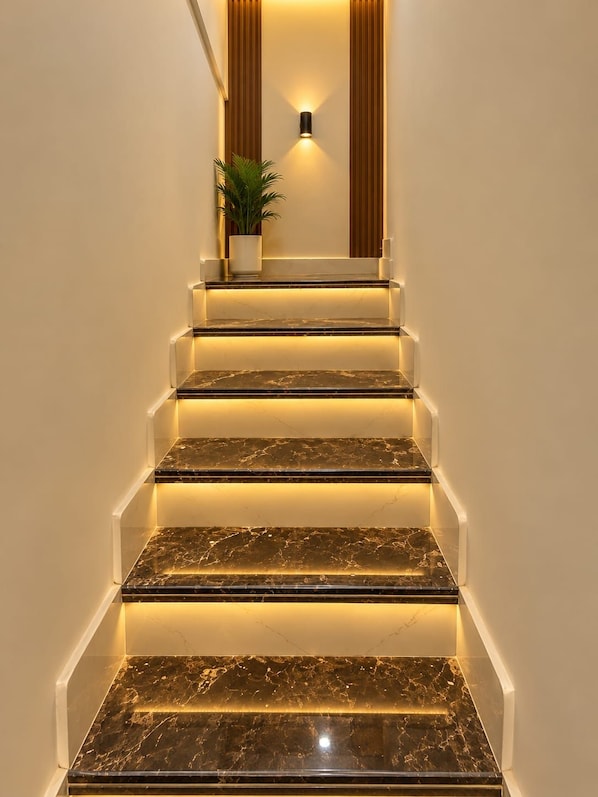 A staircase with marble steps and underglow lighting. - BnB By Rama A Luxury Stay (Varanasi)