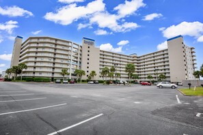 A multi-story hotel with a parking lot in front. - Beachfront condo w Gulf views, 3 pools, tennis & fitness room ~ Sleep 6 (Orange Beach)