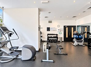 A modern gym with treadmills, dumbbells, and exercise balls. - FIRST CLASS | 2BR | Prime Location | Skyline Views (Dubai)