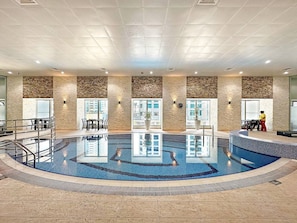A swimming pool with a tiled floor, surrounded by stone walls and windows. - FIRST CLASS | 2BR | High Floor | Stunning Sea View (Marina)