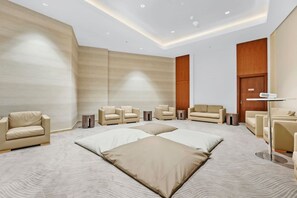A modern hotel room with a large bed, multiple seating areas, and a wooden door. - FIRST CLASS | 3BR | Burj Khalifa & Fountain Views (Dubai)
