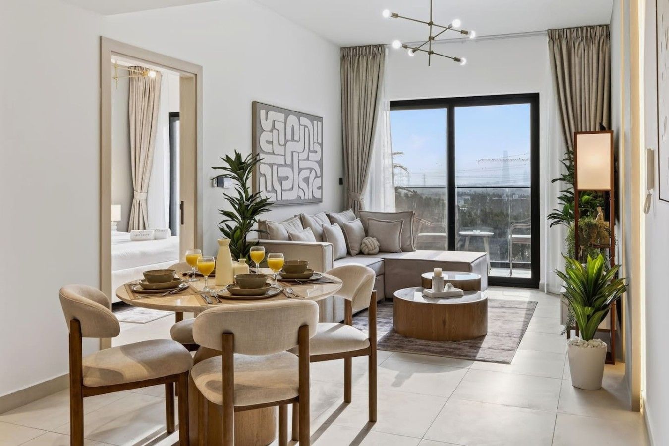 A modern living room with a dining area, large windows, and a view of the city.