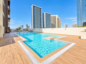A rooftop pool with a clear view of surrounding high-rise buildings. - FIRST CLASS | 1BR | Modern Sleek Escape (JVC)
