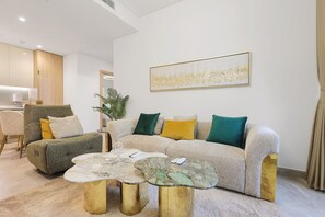 A modern living room with a sofa, armchairs, and a coffee table. - FIRST CLASS | 2BR | Tranquil Canal View Haven (Business Bay)