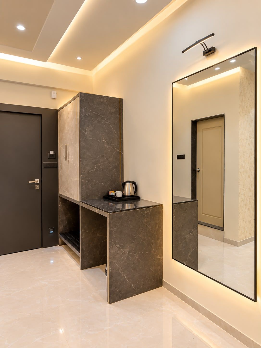 A modern bathroom with a marble vanity, a large mirror, and recessed ceiling lighting.