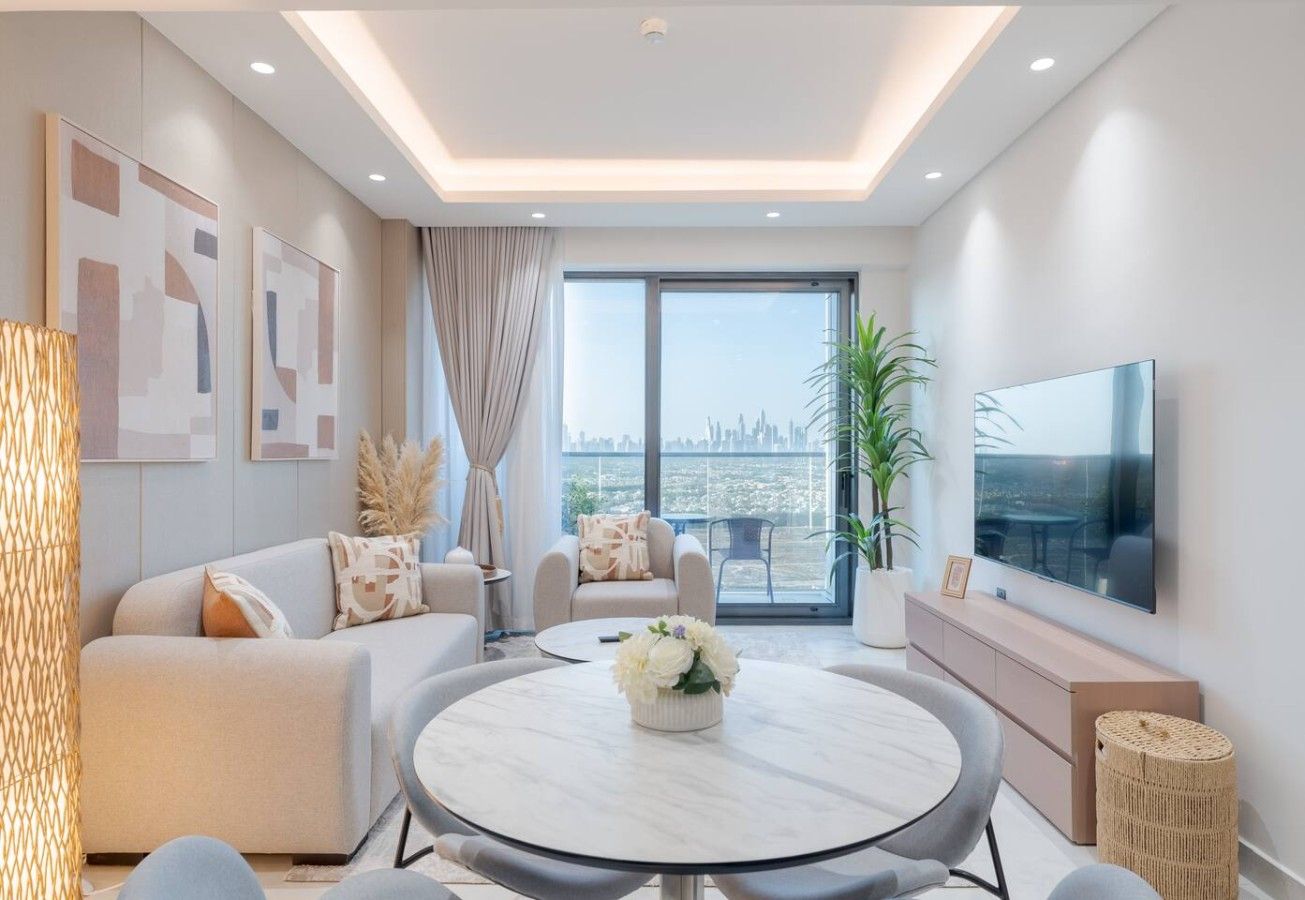 A modern living room with a round coffee table, sofas, a TV, and a city view.