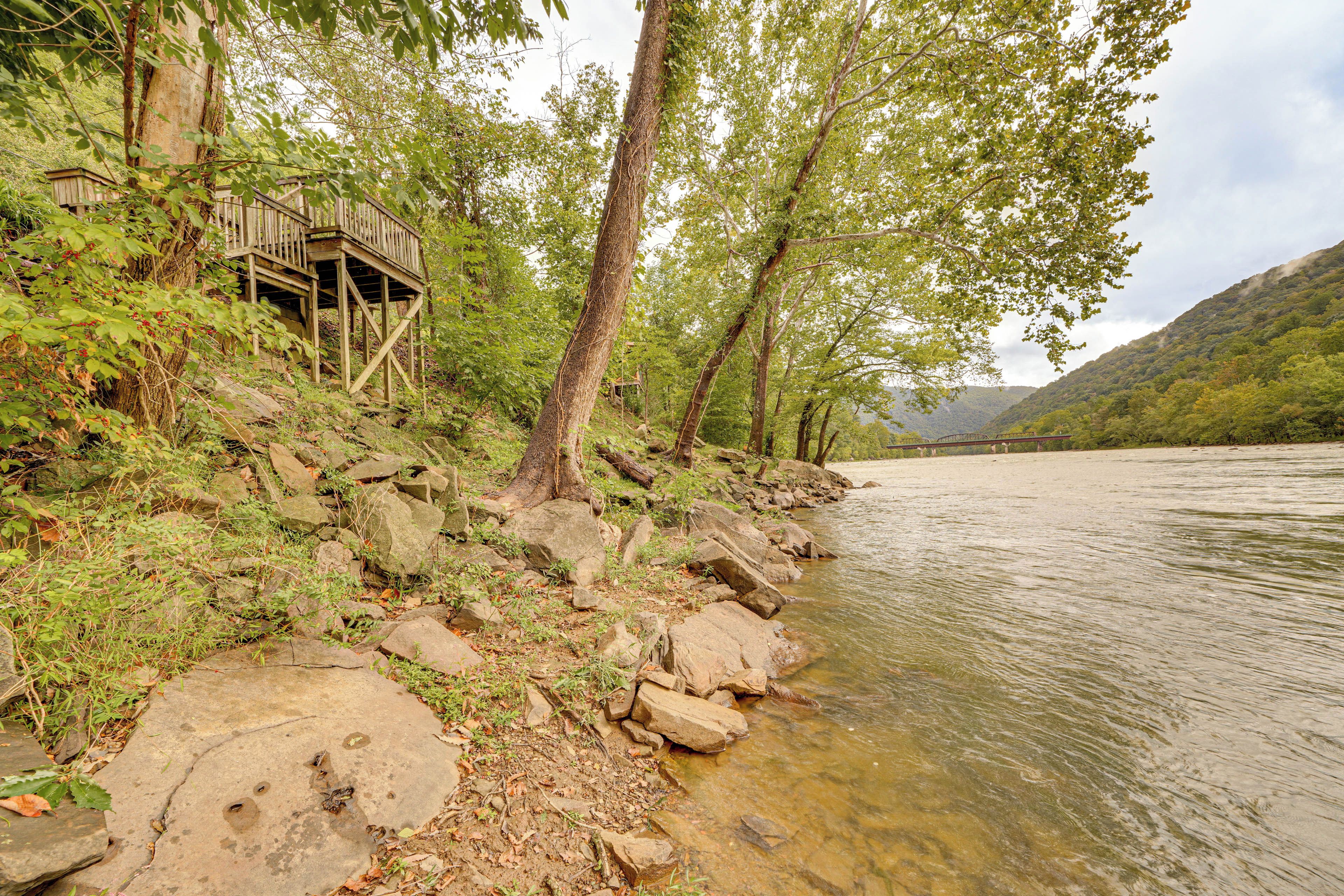 A riverside wooden structure with a natural surrounding.