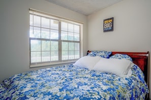 A bedroom with a bed, a window with blinds, and a wall with a motivational poster. - 7 Mi to Mall of Georgia: Fire Pit & Yard (Buford)
