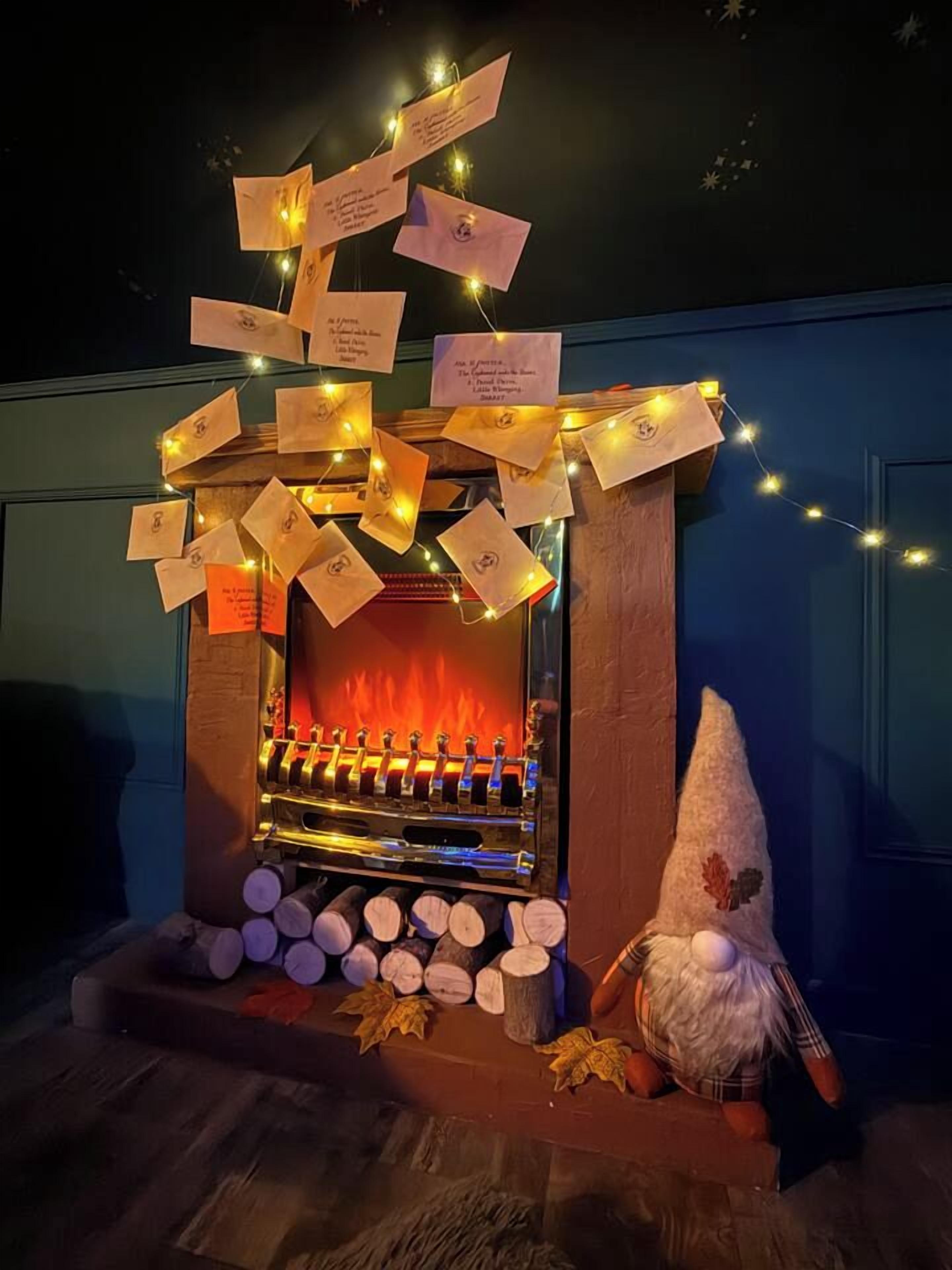 A fireplace with hanging notes and a gnome decoration.