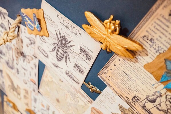 A collection of insect illustrations and a book titled 'The Italian Bee' on a table.