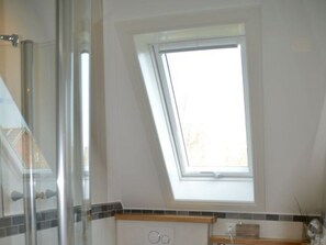 A room with a skylight, a shower area, and a kitchen counter. - Holiday Apartment With 1 Bedroom (Wyk auf Foehr)